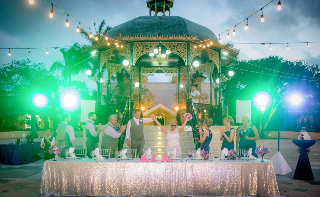 Green lighting surrounding an outdoor reception pavilion