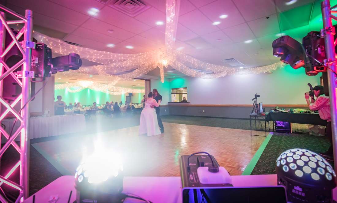 DJ booth with a truss and colorful event lights